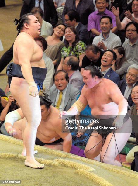 Mongolian yokozuna Kakuryu pushes Mongolian yokozuna Hakuho out of the ring to win on day fifteen of the Grand Sumo Summer Tournament at Ryogoku...