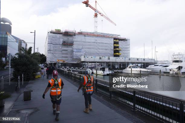 Workers walk towards the construction site of the Park Hyatt hotel in Auckland, New Zealand, on Wednesday, May 23, 2018. On the waterfront of New...