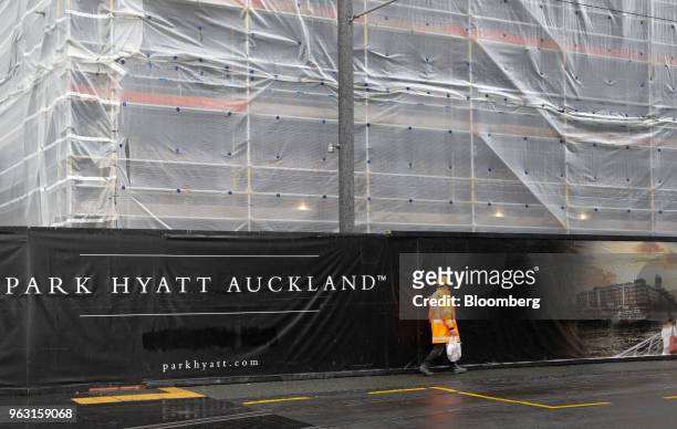 Worker walks past the construction site of the Park Hyatt hotel in Auckland, New Zealand, on Wednesday, May 23, 2018. On the waterfront of New...