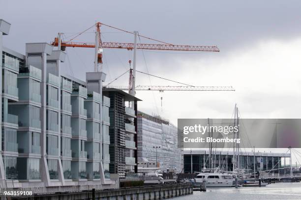 Cranes operate at the construction site of the Park Hyatt hotel in Auckland, New Zealand, on Wednesday, May 23, 2018. On the waterfront of New...