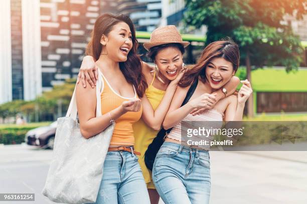 laughing girlfriends - asian group holiday stock pictures, royalty-free photos & images