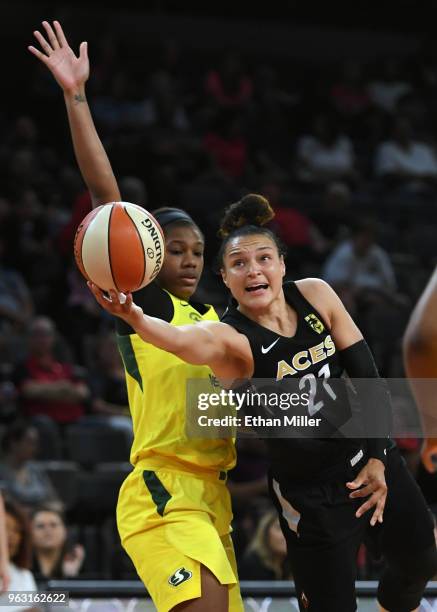 Kayla McBride of the Las Vegas Aces shoots against Teana Muldrow of the Seattle Storm during the Aces' inaugural regular-season home opener at the...
