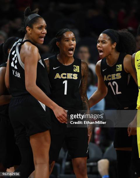 Ja Wilson, Tamera Young and Nia Coffey of the Las Vegas Aces react after Young was fouled by a Seattle Storm player during the Aces' inaugural...
