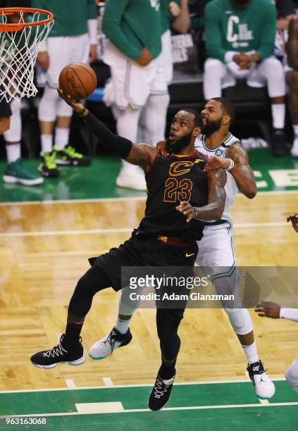 LeBron James of the Cleveland Cavaliers shoots the ball as he is fouled by Marcus Morris of the Boston Celtics in the second half during Game Seven...