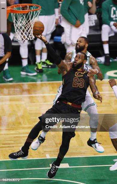 LeBron James of the Cleveland Cavaliers shoots the ball as he is fouled by Marcus Morris of the Boston Celtics in the second half during Game Seven...