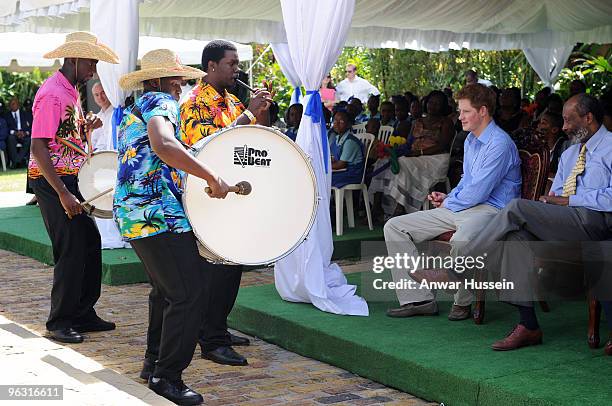 Prince Harry watches musicians at a garden party for orphaned and vulnerable children at the Garrison Museum on January 30, 2010 in Bridgetown,...