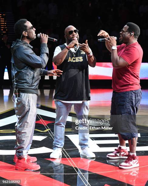 Singers Shawn Stockman, Wanya Morris and Nathan Morris of Boyz II Men perform the American national anthem before the Las Vegas Aces' inaugural...