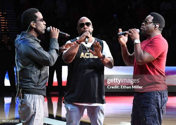 Singers Shawn Stockman, Wanya Morris and Nathan Morris of Boyz II Men perform the American national anthem before the Las Vegas Aces' inaugural...