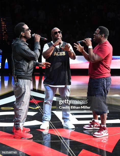 Singers Shawn Stockman, Wanya Morris and Nathan Morris of Boyz II Men perform the American national anthem before the Las Vegas Aces' inaugural...