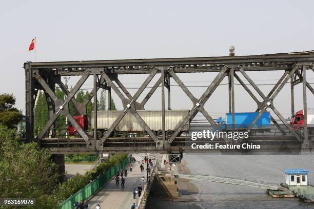 Trucks from North Korea arrive into the Chinese side on a bridge across the border river in Dandong in northeast China's Liaoning province Thursday...