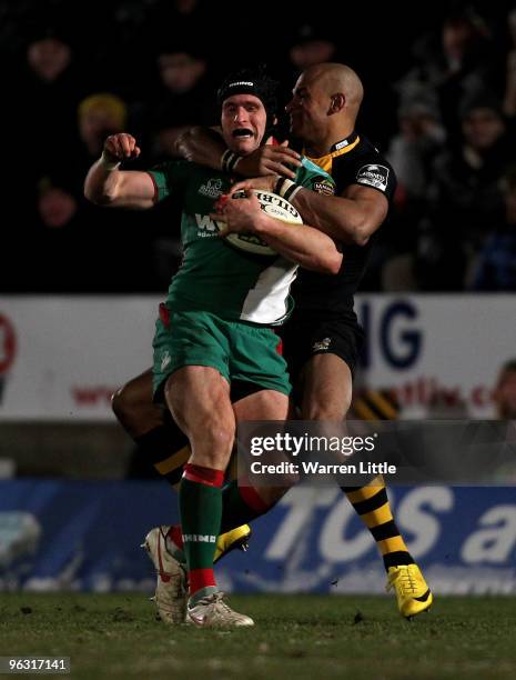 Johnanthan Edwards of The Scarlets is tackled by Tom Varndell of London Wasps during the LV=Cup between London Wasps and Llanelli Scarlets at Adams...