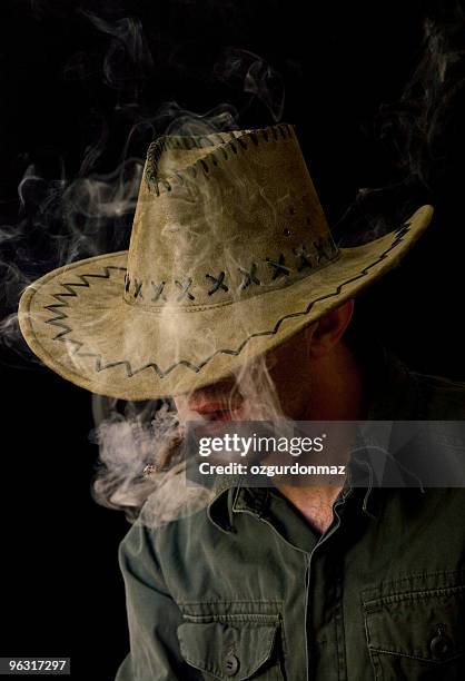 smoking cowboy - spooky smoke stock pictures, royalty-free photos & images