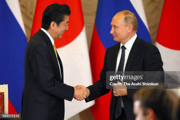 Japanese Prime Minister Shinzo Abe and Russian President Vladimir Putin shake hands after a joint press conference following their meeting at Kremlin...