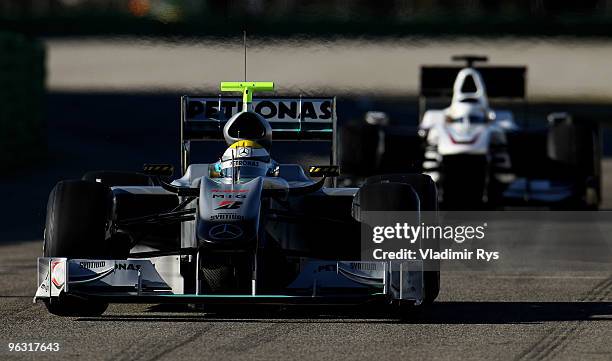 Nico Rosberg of Germany and Mercedes followed by Pedro De la Rosa of Spain and Sauber drives their cars at the Ricardo Tormo Circuit on February 1,...