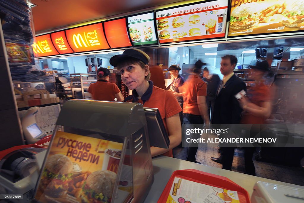 Employees serve clients in a McDonald's