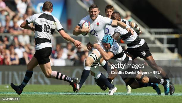 Mark Wilson of England is tackled by Justin Tipuric during the Quilter Cup match between England and the Barbarians at Twickenham Stadium on May 27,...
