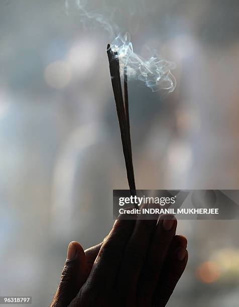 Sri Lankan Buddhist devotee offers prayers on Poya-full moon at the Kelaniya Temple in Kelaniya, Gampaha district on January 29, 2010. The...