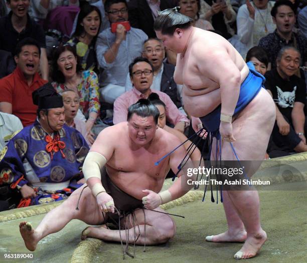 Mongolian sekiwake Ichinojo throws Mongolian yokozuna Hakuho to win on day fourteen of the Grand Sumo Summer Tournament at Ryogoku Kokugikan on May...