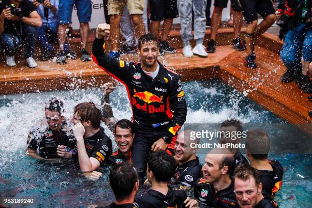 Daniel Ricciardo from Australia with Aston Martin Red Bull Tag Heuer RB14 celebrating his victory with the team at the swimming pool during the Race...