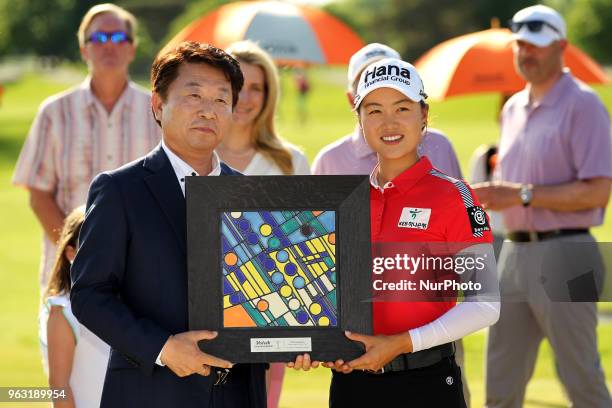 Minjee Lee of Perth Australia is presented the trophy by Don Shin, president of Volvik USA, during the final round of the LPGA Volvik Championship at...
