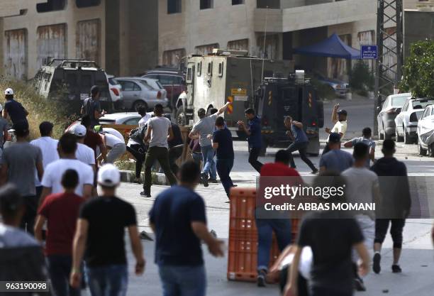 Young Palestinian men clash with Israeli soldiers in the Amari refugee camp near Ramallah in the occupied West Bank after troops stormed the camp on...