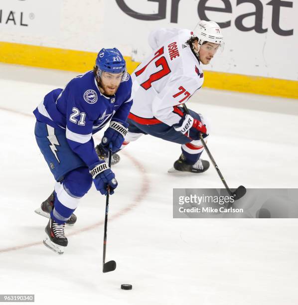 Brayden Point of the Tampa Bay Lightning avoids the check of T.J. Oshie of the Washington Capitals in Game Seven of the Eastern Conference Finals...