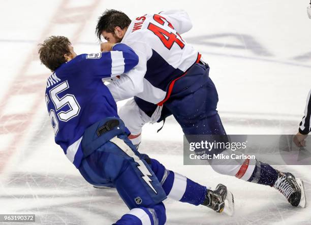Braydon Coburn of the Tampa Bay Lightning fights with Tom Wilson of the Washington Capitals in Game Seven of the Eastern Conference Finals during the...