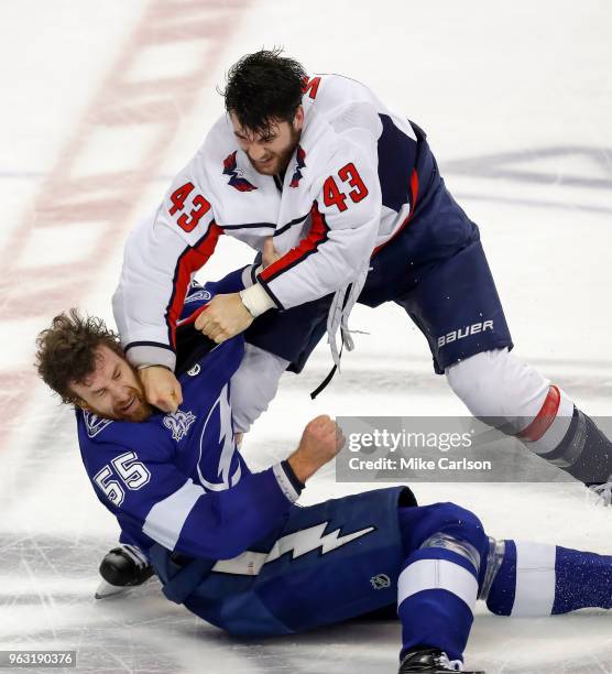 Braydon Coburn of the Tampa Bay Lightning fights with Tom Wilson of the Washington Capitals in Game Seven of the Eastern Conference Finals during the...