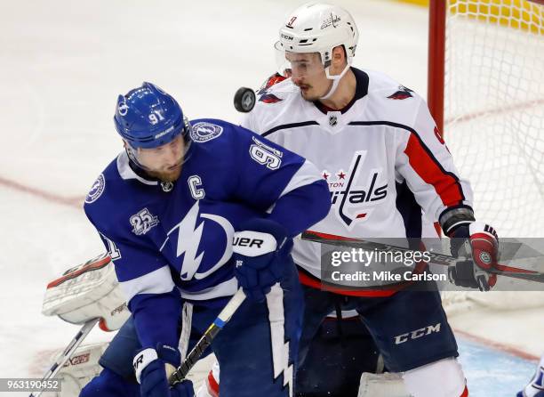 Steven Stamkos of the Tampa Bay Lightning and Dmitry Orlov of the Washington Capitals look for a loose puck in Game Seven of the Eastern Conference...