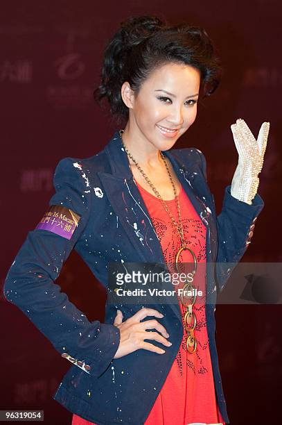 Singer Coco Lee poses for the media wearing a copy of the iconic white rhinestone glove worn by Michael Jackson during the opening ceremony of the MJ...