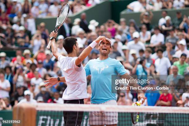 French Open Tennis Tournament - Rafael Nadal of Spain and Novak Djokovic of Serbia celebrate after winning a tie break doubles exhibition match...