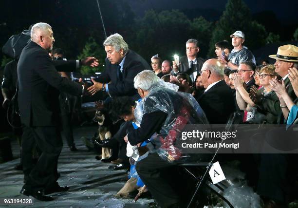 Academy Award-nominated actor Graham Greene greets veteran Bill Rider during the 2018 National Memorial Day Concert at U.S. Capitol, West Lawn on May...