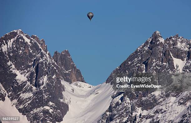 Hot air balloon on top of the mountains Kaisergebirge on January 21, 2009 in Kitzbuehel, Austria.