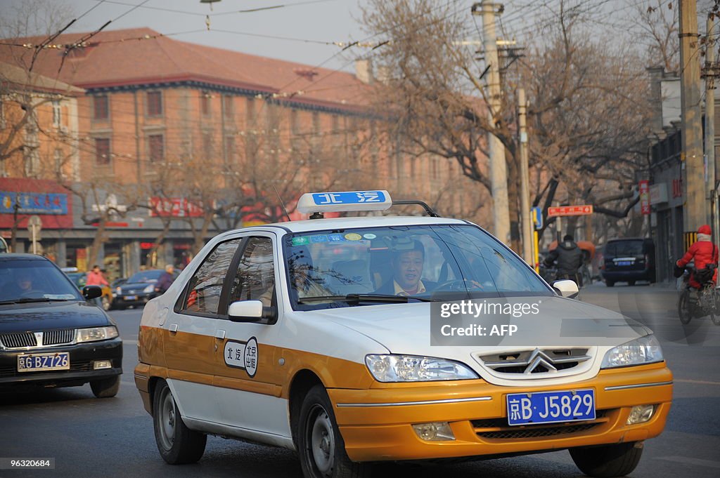 A taxi makes its way along a street in B