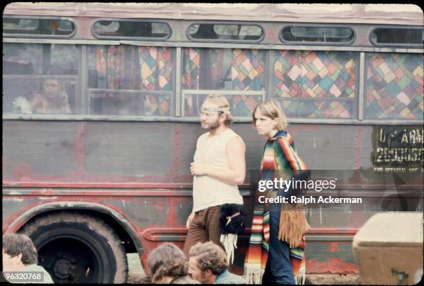 People outside one of the buses the Hog Farmers drove from New Mexico, at the Woodstock music festival, August 1969.