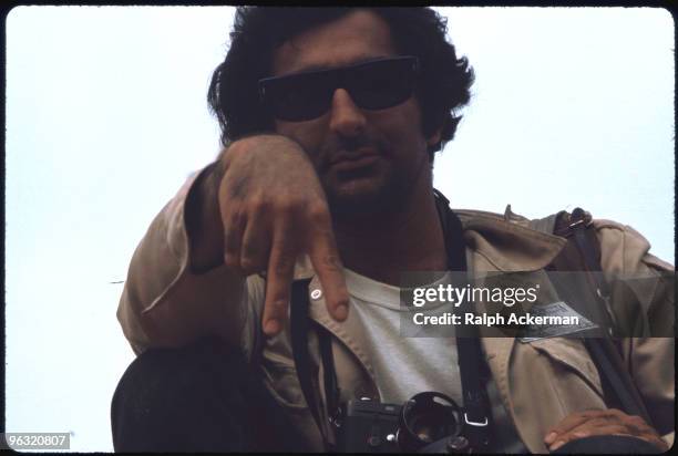 Photographer Jim Marshall gives the two finger hand signal at the Woodstock music festival, August 1969.