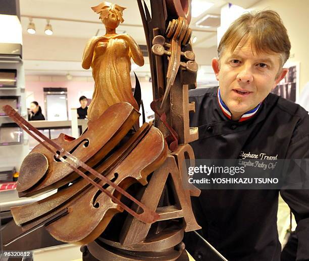 French chocolatier Stephane Treand displays an opera themed chocolate made sculpture at the opening of the Salon du Chocolat at Tokyo's Isetan...