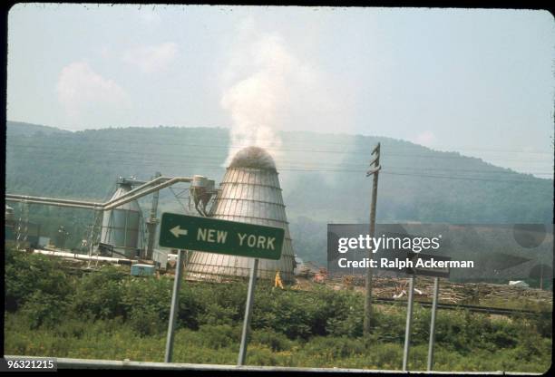 View from the window of the bus, the countryside of Bethel and the Woodstock area--agricultural burning, green mountainsides, New York highway sign,...