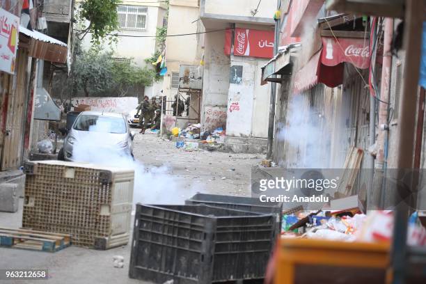 Israeli soldiers intervene Palestinians, who protest Israel's invasion at Al-Amari Refugee Camp, with tear gas in Ramallah, West Bank on May 28,...