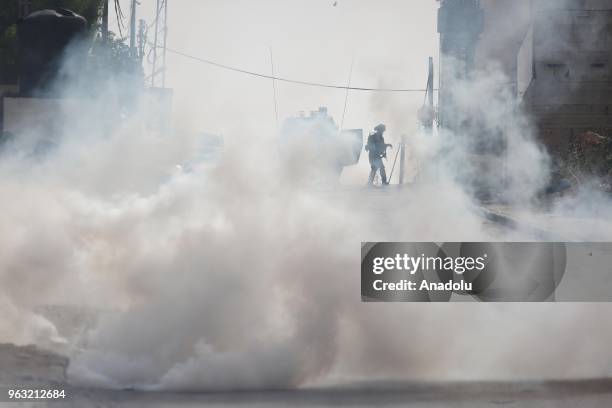 Israeli soldiers intervene Palestinians, who protest Israel's invasion at Al-Amari Refugee Camp, with tear gas in Ramallah, West Bank on May 28,...