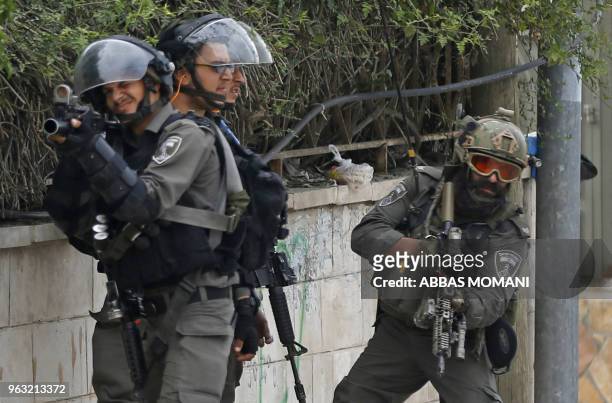 Israeli troops take position as they clash with Palestinian youth in the Amari refugee camp near Ramallah in the occupied West Bank after they...