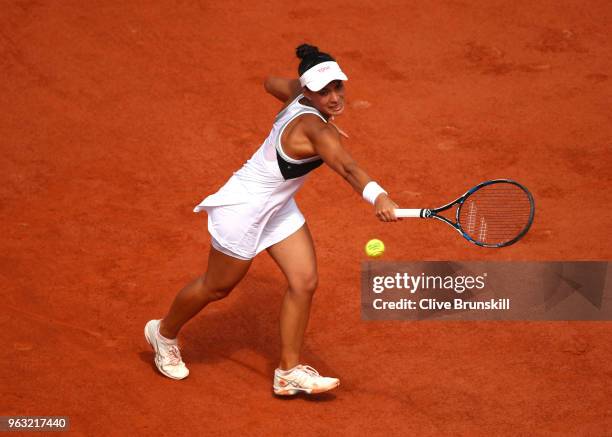 Veronica Cepede Royg of Paraguay plays a backhand during the ladies singles first round match aganist Petra Kvitova of Czech Republic during day two...