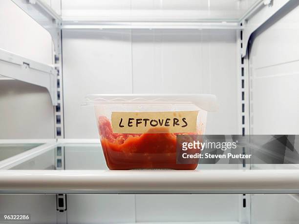 single leftover container on refrigerator shelf - leftover stockfoto's en -beelden
