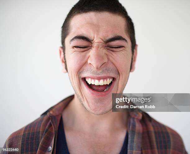 young man laughing - crying man stock pictures, royalty-free photos & images