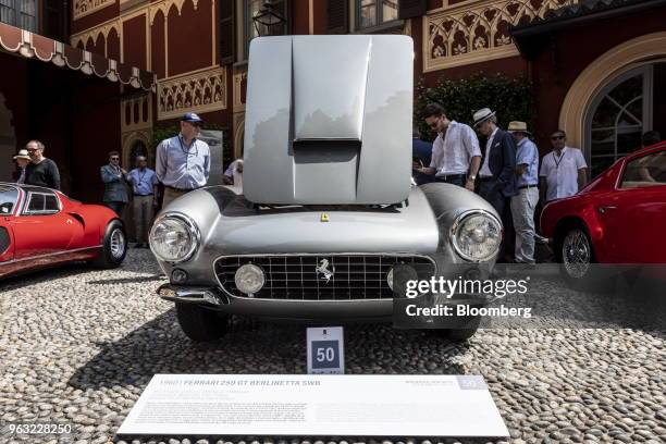 The hood of a 1960 Ferrari NV 250 GT Berlinetta SWB is opened for visitors at the 2018 Concorso D'Eleganza at Villa d'Este in Cernobbio, Italy, on...