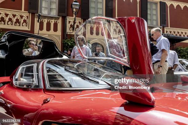 Gull-wing door of a 1968 Alfa Romeo Automobiles SpA 33/2 Stradale automobile is opened for visitors at the 2018 Concorso D'Eleganza at Villa d'Este...