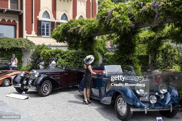 Visitor reviews a 1937 Bentley Motors Ltd. 4 1/2 Liter cabriolet, right, at the 2018 Concorso D'Eleganza at Villa d'Este in Cernobbio, Italy, on...