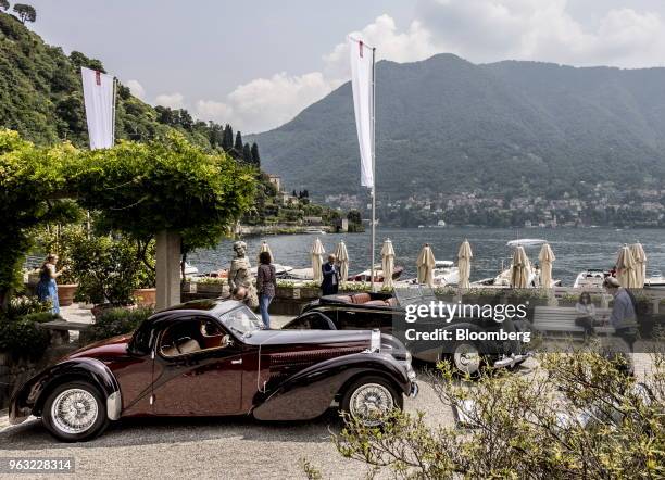 Bugatti Automobiles SAS 57, left, and a 1936 Lancia Automobiles SpA Astura Serie III stand on display at the 2018 Concorso D'Eleganza at Villa d'Este...