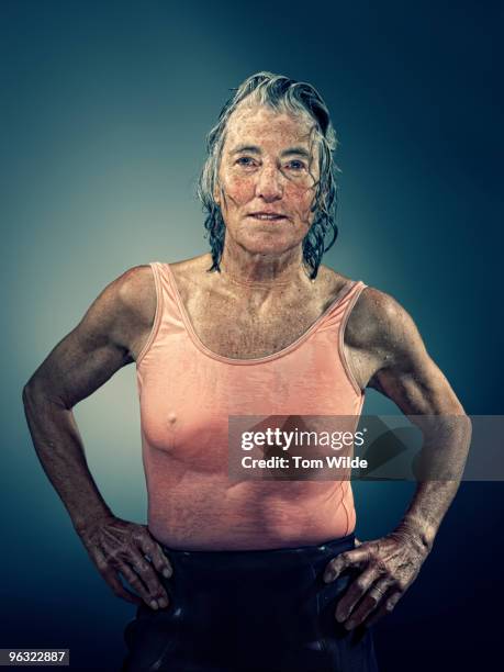 middle aged female surfer with wet hair and body - grittywomantrend stock pictures, royalty-free photos & images