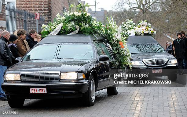 Mourners view the vehicles carrying the bodies of Charlotte Francois and Pierre Guilliams, victims of last Wednesday's gas explosion that destroyed a...